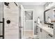 Bathroom featuring a gray vanity, granite countertops, and a modern, tiled shower at 465 Mandalay Rd, Orlando, FL 32809