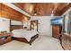 Cozy bedroom with wood-paneled ceiling, neutral carpet, and ample natural light at 465 Mandalay Rd, Orlando, FL 32809