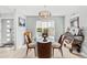 Elegant dining room with round glass table, wood chairs, and stylish chandelier lighting at 465 Mandalay Rd, Orlando, FL 32809