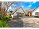 The attached garage has a contemporary door and is surrounded by manicured landscaping and hardscapes at 465 Mandalay Rd, Orlando, FL 32809