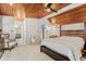 This main bedroom features a light carpet, a ceiling fan, and is connected to the main bathroom at 465 Mandalay Rd, Orlando, FL 32809