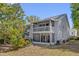 Two-story home featuring a screened porch and a second-story balcony at 4801 Coachmans Dr # 2, Orlando, FL 32812