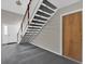 Welcoming entryway featuring stairs with black treads and a contrasting white banister at 4801 Coachmans Dr # 2, Orlando, FL 32812