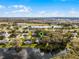 Expansive aerial view of a suburban neighborhood, showcasing a peaceful pond and mature trees at 5219 Hammock Cir, St Cloud, FL 34771