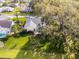 The aerial shot showcases the house location with mature trees, landscaping, and a screened-in pool at 5219 Hammock Cir, St Cloud, FL 34771