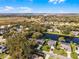 Scenic aerial shot showcasing a charming community with lush trees and serene water features at 5219 Hammock Cir, St Cloud, FL 34771