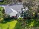 Aerial view of home showcasing a large backyard with lush landscaping and screened in pool area at 5219 Hammock Cir, St Cloud, FL 34771