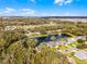 Scenic aerial shot showcasing a charming community with lush trees and serene water features at 5219 Hammock Cir, St Cloud, FL 34771