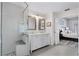 Bright bathroom featuring a double vanity with a glass shower and marble countertops at 5219 Hammock Cir, St Cloud, FL 34771