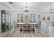 Formal dining room features wood floors, a large table with seating, and a decorative chandelier at 5219 Hammock Cir, St Cloud, FL 34771