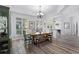 Open dining area featuring a wooden table, stylish furnishings, and a view of the foyer at 5219 Hammock Cir, St Cloud, FL 34771