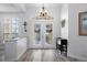 Bright foyer with double doors, transom window, chandelier, and stylish flooring at 5219 Hammock Cir, St Cloud, FL 34771