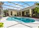 Sparkling swimming pool with screened-in enclosure is surrounded by a patio area, perfect for enjoying the outdoors at 5219 Hammock Cir, St Cloud, FL 34771