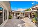 Outdoor patio with travertine tile, sail shade, solar panels and outdoor dining at 533 Balmoral Rd, Winter Park, FL 32789