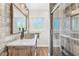 Bathroom featuring stone vessel sink, sliding shower glass and quartz countertop at 533 Balmoral Rd, Winter Park, FL 32789