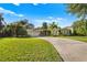 Attractive single-story home featuring a well-manicured lawn and a paved driveway at 533 Balmoral Rd, Winter Park, FL 32789