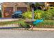 A majestic peacock struts along the sidewalk in front of a well-maintained home at 533 Balmoral Rd, Winter Park, FL 32789