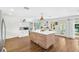 Spacious kitchen featuring a center island, white cabinets, and wood-look tile flooring at 533 Balmoral Rd, Winter Park, FL 32789