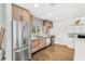 Kitchen with stainless steel fridge and appliances, modern cabinetry, and mosaic backsplash at 533 Balmoral Rd, Winter Park, FL 32789