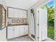 Laundry room featuring white cabinets, butcher block countertop, and access to the outdoors at 533 Balmoral Rd, Winter Park, FL 32789