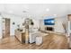 Bright living room with a stone accent wall, fireplace, TV, and hardwood floors at 533 Balmoral Rd, Winter Park, FL 32789