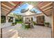 Outdoor dining area with sunshade and travertine floors at 533 Balmoral Rd, Winter Park, FL 32789