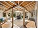 Spacious outdoor patio with a wooden ceiling, travertine floors, and a dining set at 533 Balmoral Rd, Winter Park, FL 32789