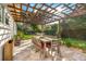 Inviting outdoor dining area with a large table and pergola, perfect for enjoying sunny days at 533 Balmoral Rd, Winter Park, FL 32789