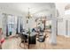 Dining room with a black table and chairs, tile flooring, and a weight lifting set at 5361 Tortuga Dr, Orlando, FL 32837