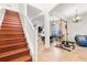 Bright foyer featuring wood stairs, a chandelier, and an open floor plan at 5361 Tortuga Dr, Orlando, FL 32837