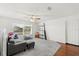 Minimalist living room with carpet, a gray couch, and a window that offers views of the landscape at 5361 Tortuga Dr, Orlando, FL 32837