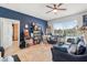 Comfortable living room with blue accent wall, tile flooring, view of the pool, and a ceiling fan at 5361 Tortuga Dr, Orlando, FL 32837