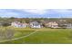 An aerial view of several luxury homes on a golf course, each with a pool at 5558 Brookline Dr, Orlando, FL 32819