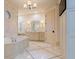 Luxurious bathroom featuring marble accents, elegant fixtures, and a jetted tub at 5558 Brookline Dr, Orlando, FL 32819