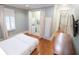 Comfortable bedroom featuring hardwood floors and a convenient laundry closet at 5558 Brookline Dr, Orlando, FL 32819