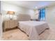 Cozy bedroom featuring neutral tones and a decorative headboard on warm travertine flooring at 5558 Brookline Dr, Orlando, FL 32819