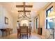 A dining room featuring tile floors, modern chandelier and large table with seating for eight at 5558 Brookline Dr, Orlando, FL 32819