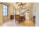 A dining room featuring tile floors, modern chandelier and large table with seating for eight at 5558 Brookline Dr, Orlando, FL 32819