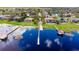 Aerial view of waterfront homes featuring private docks, screened in pools, and lush landscaping on a picturesque lake at 644 Strihal Loop, Oakland, FL 34787