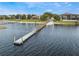 Lakeside view featuring a long dock extending into the water, sunny day at 644 Strihal Loop, Oakland, FL 34787