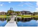 Scenic waterfront home featuring a private dock on a serene lake with lush landscaping and inviting outdoor space at 644 Strihal Loop, Oakland, FL 34787