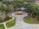 Aerial view of John's Landing entrance with lush landscaping and a guard house at 644 Strihal Loop, Oakland, FL 34787