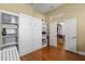 This flex room features a Murphy bed, built-in shelving, and an open doorway, all designed with hardwood floors at 644 Strihal Loop, Oakland, FL 34787