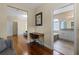 Hallway featuring hardwood floors, a desk, and a view into the bathroom, which offers modern fixtures at 644 Strihal Loop, Oakland, FL 34787