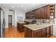 Stylish kitchen with dark wood cabinets, granite countertops, and stainless steel appliances at 644 Strihal Loop, Oakland, FL 34787