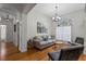 Cozy living room with hardwood floors, comfortable seating, and natural light from large windows at 644 Strihal Loop, Oakland, FL 34787