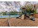 Well-maintained community playground with a slide, climbing structure, and cushioned ground cover at 644 Strihal Loop, Oakland, FL 34787