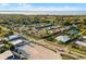 An aerial view captures the neighborhood's layout, including ponds and lush landscaping, near the ocean at 696 Orange Belt Loop, Winter Garden, FL 34787