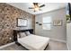 Stylish bedroom features a brick accent wall, murphy bed, ceiling fan, and lots of natural light at 696 Orange Belt Loop, Winter Garden, FL 34787