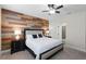 Bedroom with a wood accent wall and view into the bathroom at 696 Orange Belt Loop, Winter Garden, FL 34787